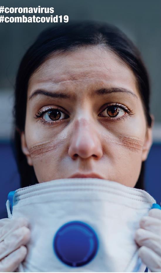 A nurse whose mask left traces on her face.